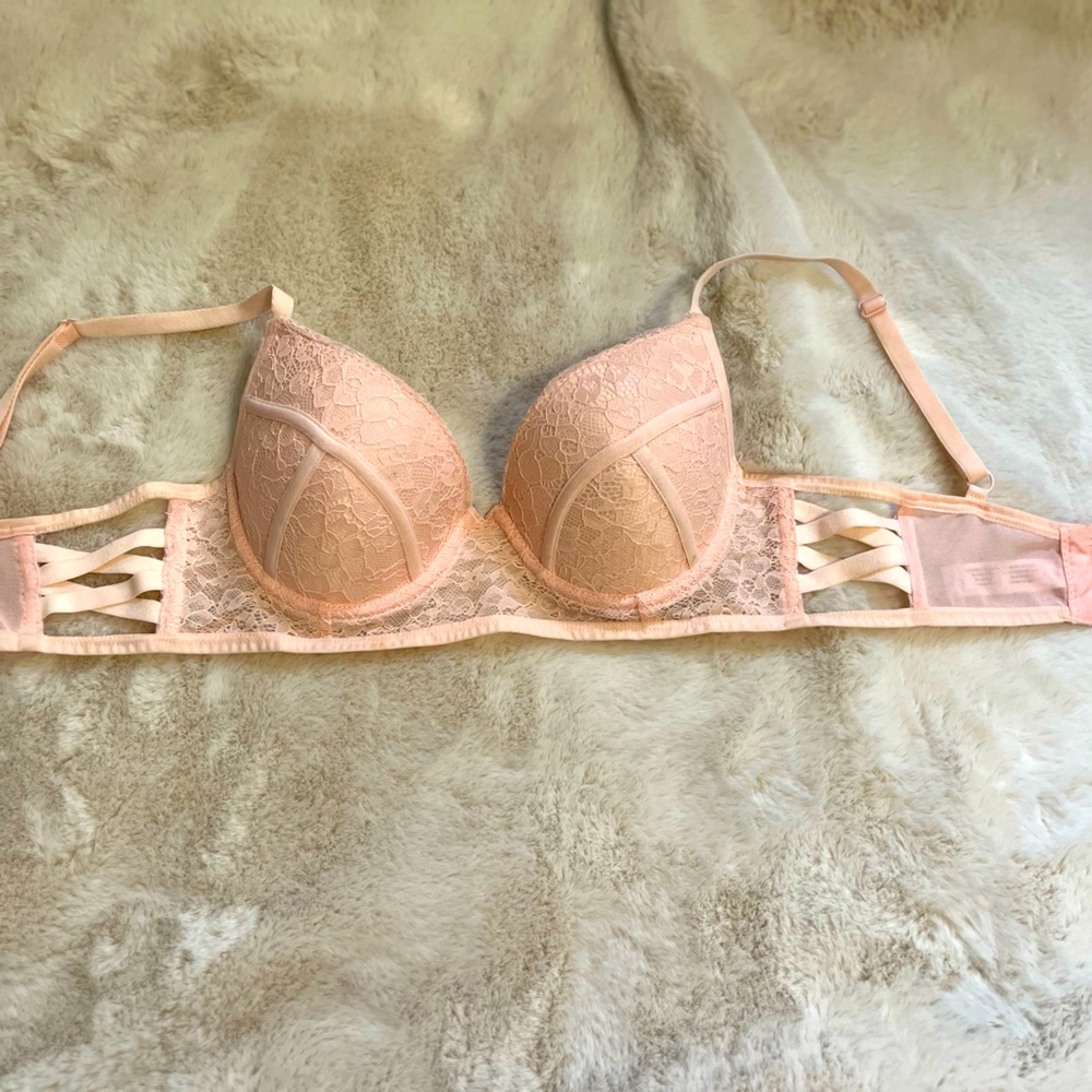 Lacy pink bra with side straps and triple hooks